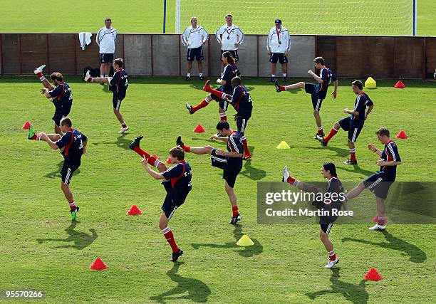 Team members of Bayern Muenchen stretch during the FC Bayern Muenchen training session at the Al Nasr training ground on January 4, 2010 in Dubai,...