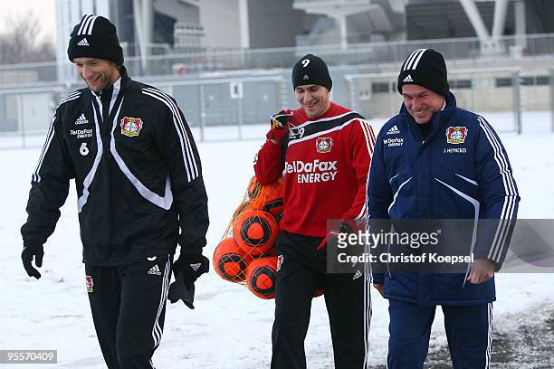 Simon Rolfes, Patrick Helmes and head coach Jupp Heynckes of Bayer Leverkusen walk to their the training session at the training ground of Beyer...