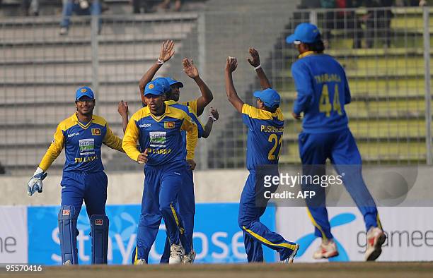 Sri Lankan cricketers celebrate after the dismissal of the Bangladeshi cricket captain Shakib Al Hasan during the Tri-Nation Tournament at The Sher-e...