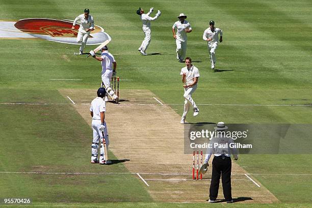 Morne Morkel of South Africa celebrates taking the wicket of Andrew Strauss of England for 2 runs after he was caught behind by Mark Boucher during...