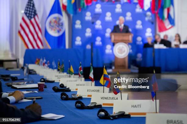 The Venezuelan flag and placard sit on a table during while U.S. Vice President Mike Pence, top center, speaks in the Hall of the Americas at the...