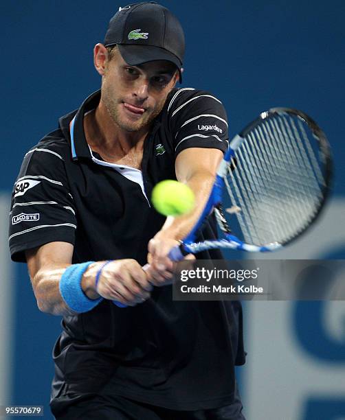 Andy Roddick of the USA plays a backhand in his first round match against Peter Luczak of Australia during day two of the Brisbane International 2010...