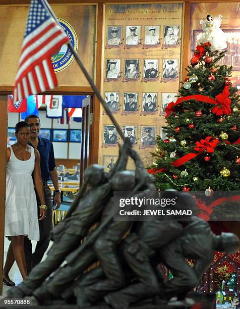 President Barack Obama and First Lady Michelle Obama arrive at the Marine Corp Base mess hall to greet soldiers and their family member for Christmas...