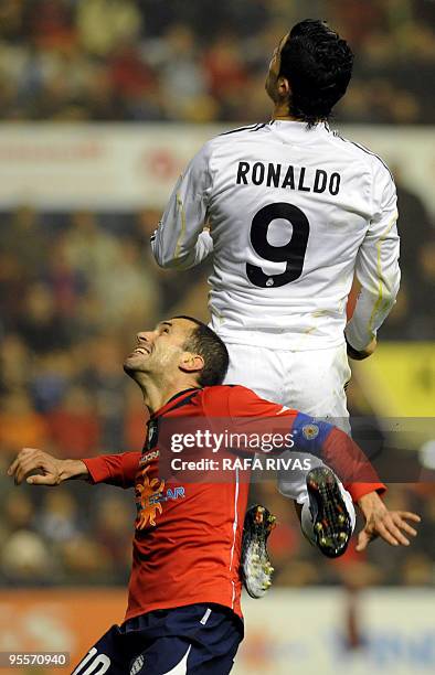 Osasuna's Patxi Punal vies with Real Madrid's Portuguese forward Cristiano Ronaldo during a Spanish league football match, on January 3 at Reyno de...