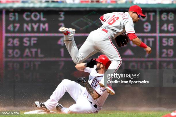 Philadelphia Phillies second baseman Cesar Hernandez completes a double play on sliding Washington Nationals first baseman Matt Adams during the game...