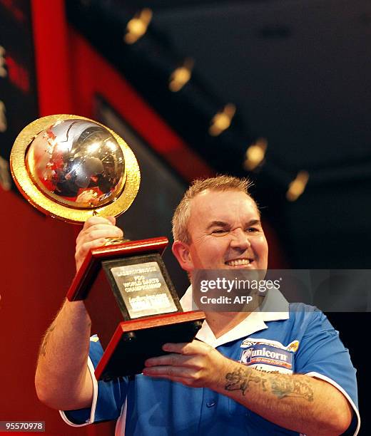 England's Phil Taylor celebrates his 15th World champion title after defeating Australia's Simon Whitlock in the final of the 2010 World Darts...