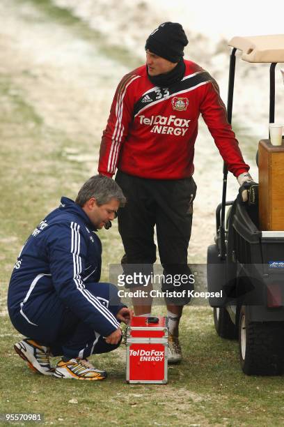 Physiotherapist Sven Elsinger takes care of goalkeeper Rene Adler during the training session of Bayer Leverkusen at the training ground on January...