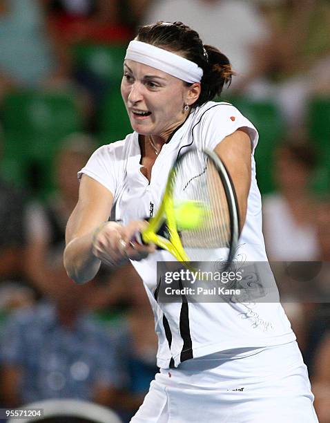 Yaroslava Shvedova of Kazakhstan plays a backhand shot in her match against Laura Robson of Great Britain in the Group B match between Great Britain...