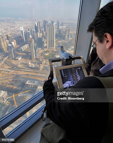 Visitor uses an electronic telescope on the observation deck on the 126th floor of the Burj Dubai, the world's tallest building, in Dubai, United...