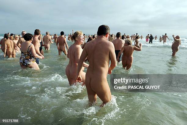 Some of the 300 people take part in a traditional bath ending the year, on December 31, 2009 on the nudist beach of Le Cap d'Agde, southern France....