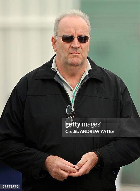 Australian cricket umpire Darrell Hair looks on as the England team practice in the nets at Old Trafford, Manchester, north-west England, on May 22,...