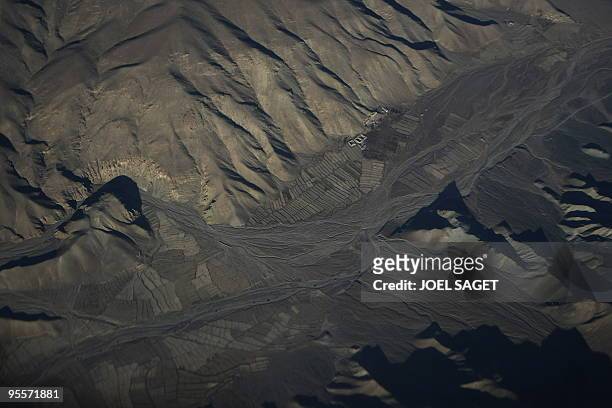 An aerial view of agricultural ground near the Afghan mountains are seen from a French military plane on December 31, 2009. France on December 16...