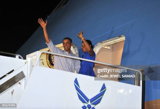 President Barack Obama and First Lady Michelle Obama board the Air Force One at the Hickam Air Force Base in Honolulu, Hawaii, on January 3, 2010....