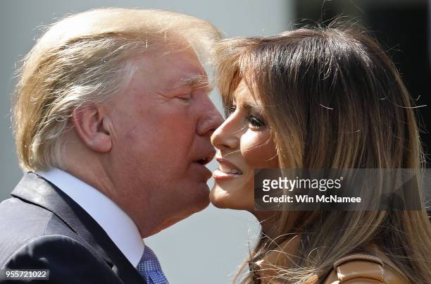 President Donald Trump kisses U.S. First lady Melania Trump after she spoke in the Rose Garden of the White House May 7, 2018 in Washington, DC....