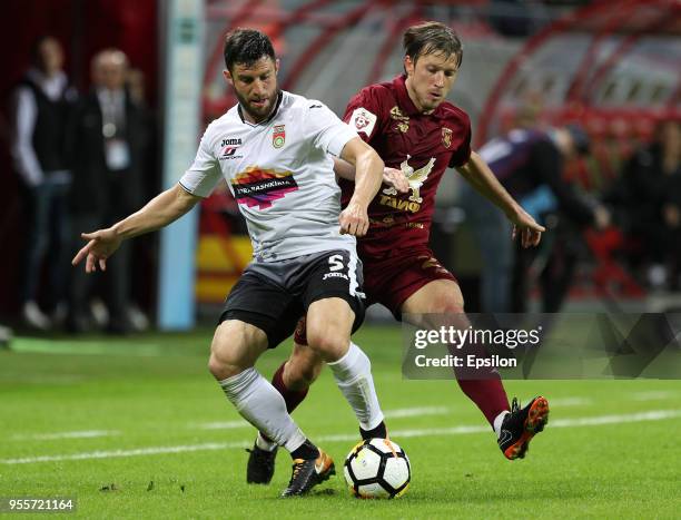 Oleg Kuzmin of FC Rubin Kazan vies for the ball with Bojan Jokic FC Ufa during the Russian Premier League match between FC Rubin Kazan and FC Ufa at...