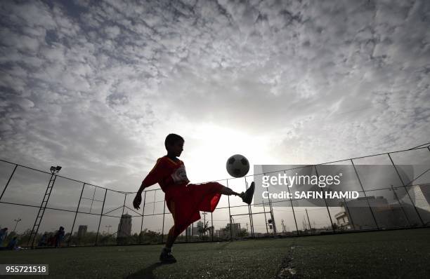 An Iraqi boy who lost his limb in the government offensive to retake the city of Mosul from the Islamic State group, play football in Arbil, the...