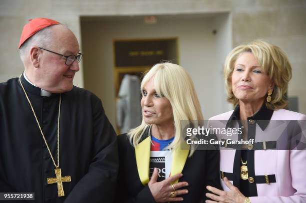His Eminence Timothy Michael Cardinal Dolan Archbishop of New York, designer Donnatella Versace and Christine Schwarzman attend 'Heavenly Bodies:...