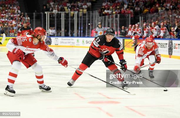 Philip Larsen of Team Denmark, Bo Horvat of Team Canada and Morten Madsen of Team Denmark during the IIHF World Championship game between Canada and...