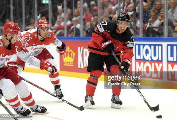 Oliver Lauridsen of Team Denmark and Jaden Schwartz of Team Canada during the IIHF World Championship game between Canada and Denmark at Jyske Bank...