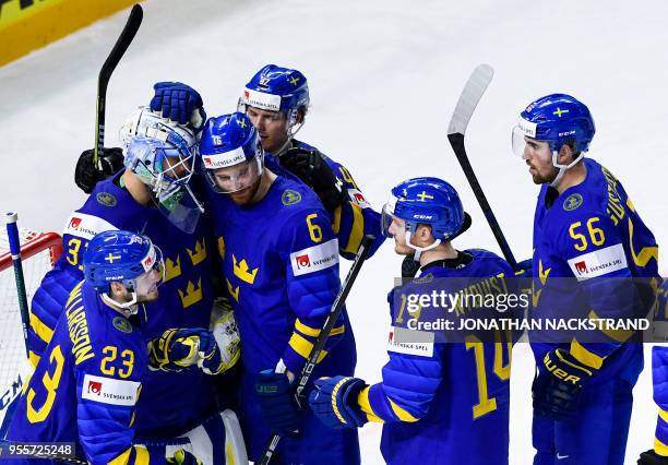 Sweden's goalie Anders Nilsson is congratulated by teamates at the end of the group A match Sweden vs France of the 2018 IIHF Ice Hockey World...