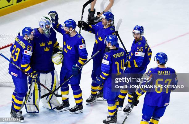 Sweden's goalie Anders Nilsson is congratulated by teamates at the end of the group A match Sweden vs France of the 2018 IIHF Ice Hockey World...