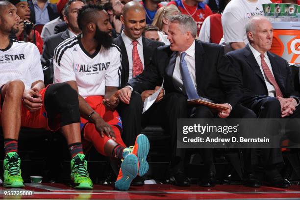 Assistant Coach Brett Brown chats with James Harden of the West All-Stars in the game against the East All-Stars during the 2013 NBA All-Star Game on...