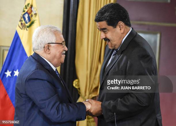 Venezuelan President Nicolas Maduro greets Palestinian President Mahmud Abbas, during a meeting at the Miraflores presidential palace in Caracas on...