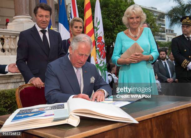 Prince Charles, Prince of Wales signs as honorary citizen of Nice as Mayor of Nice Christian Estrosi and Camilla, Duchess of Cornwall look on during...