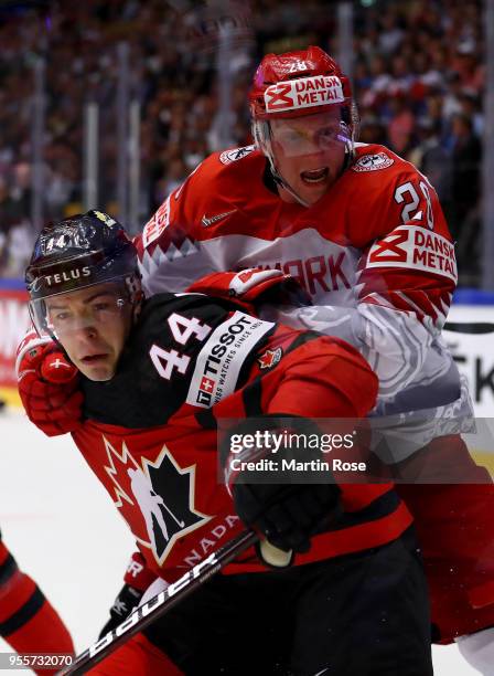 Jean Gabriel Pageau of Canada and Emil Kristensen of Denmark battle for the puck during the 2018 IIHF Ice Hockey World Championship group stage game...