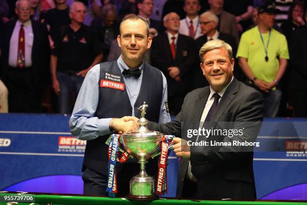 Mark Stebbings, Managing Director of Betfred pose for a picture with Mark Williams of Wales and his trophy after he won the tournament during day...