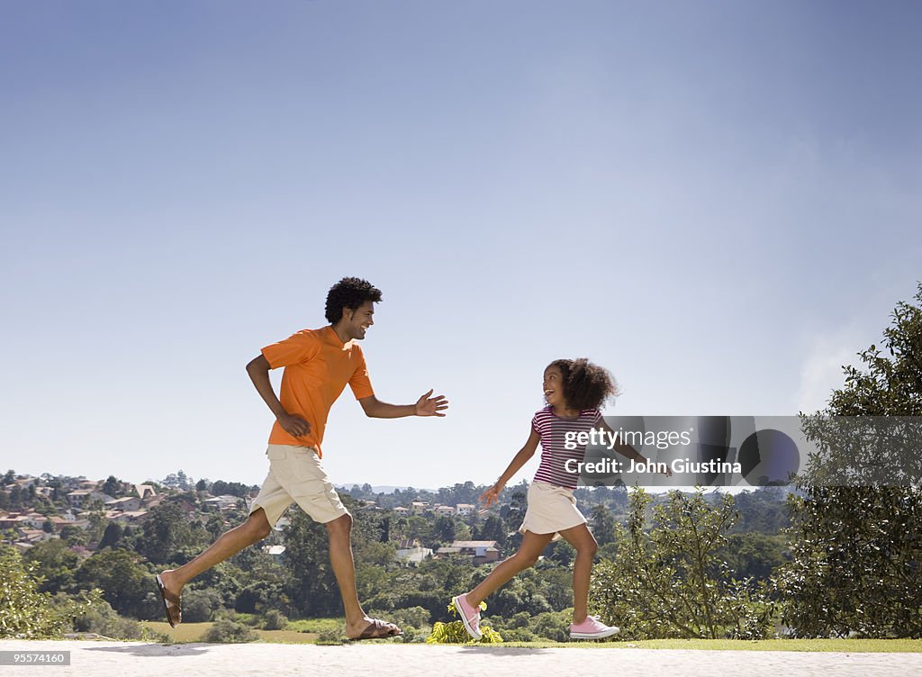 Father chases daughter outside.