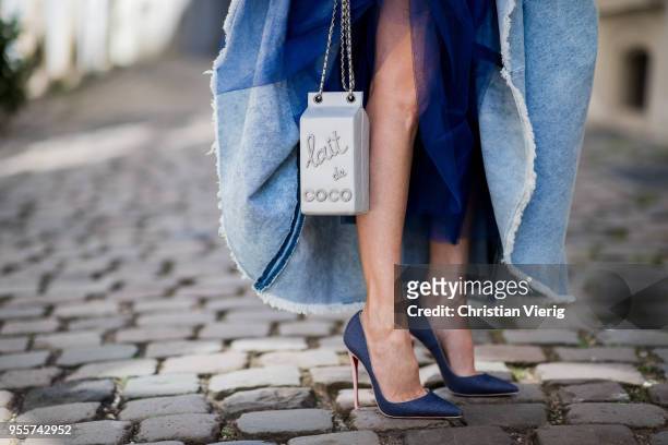 Alexandra Lapp wearing a light blue cotton strapless bustier denim dress by Natasha Zinko, blue Levis denim jacket, the Chanel Lait de coco milk...