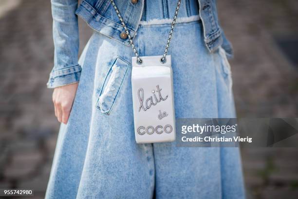 Alexandra Lapp wearing a light blue cotton strapless bustier denim dress by Natasha Zinko, blue Levis denim jacket, the Chanel Lait de coco milk...