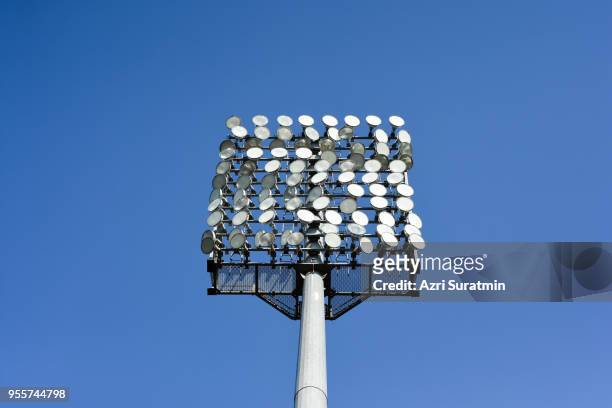 stadium light over blue sky - poteau dappui photos et images de collection