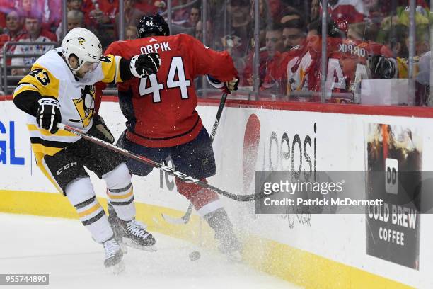 Brooks Orpik of the Washington Capitals and Conor Sheary of the Pittsburgh Penguins battle for the puck in the second period in Game Five of the...