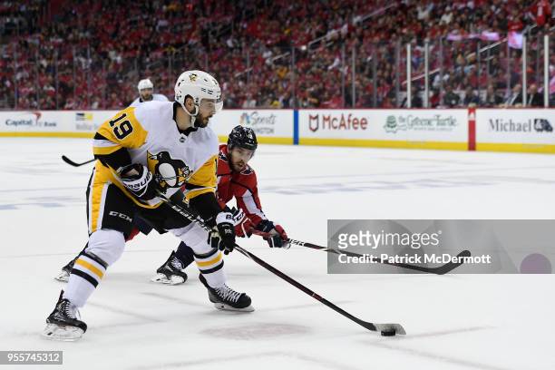 Derick Brassard of the Pittsburgh Penguins skates with the puck against Chandler Stephenson of the Washington Capitals in the second period in Game...