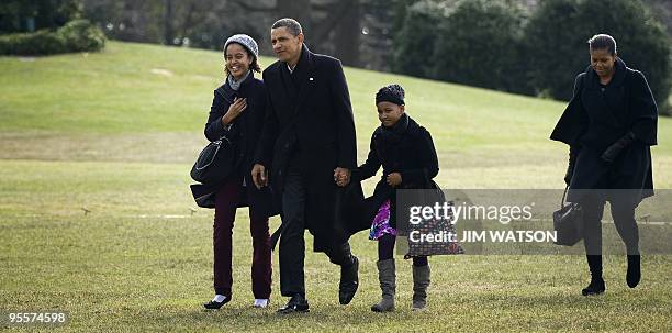 President Barack Obama arrives on the South Lawn of the White House in Washington, DC, with First Lady Michelle Obama and his daughter Sasha and...