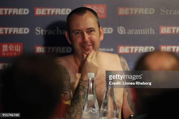 Mark Williams of Wales speaks to the media naked during a press conference after winning the tournament during day seventeen of World Snooker...