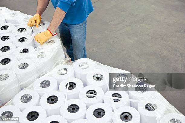 a man packing rolls of paper into boxes - toilet paper stock pictures, royalty-free photos & images