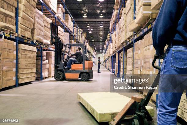 staffs working different tasks in a warehouse - forklift stock pictures, royalty-free photos & images