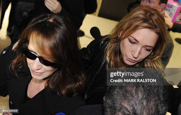 Laura Smet , daughter of French rock legend Johnny Hallyday, and her mother Nathalie Baye are jostled by media as they arrive at Los Angeles airport...
