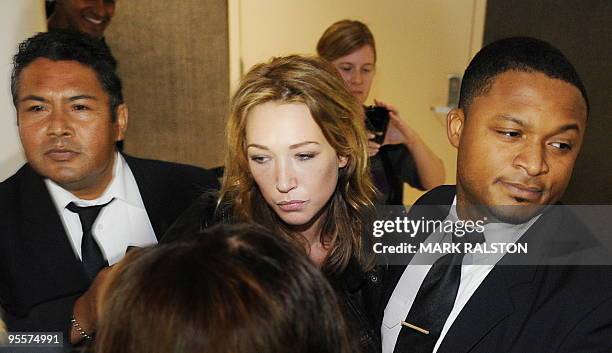 Laura Smet , daughter of French rock legend Johnny Hallyday, is escorted by security as she arrives at Los Angeles airport from France to visit her...