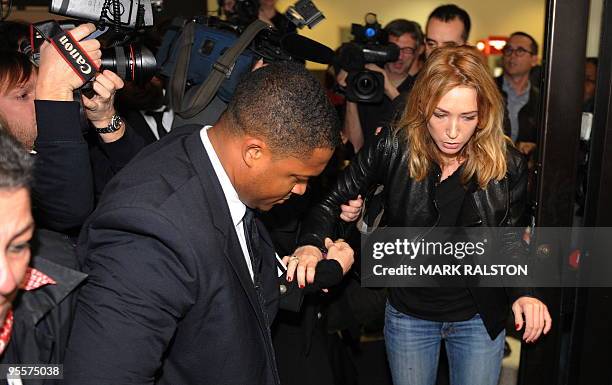 Laura Smet , daughter of French rock legend Johnny Hallyday, is jostled by media as she arrives at Los Angeles airport from France to visit her...