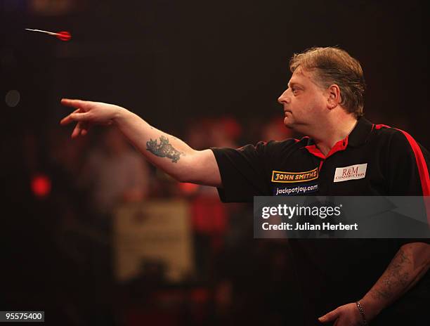 Garry Thompson of England in action against Ross Montgomery of Scotland during the first round Match of World Professional Darts Championship at The...