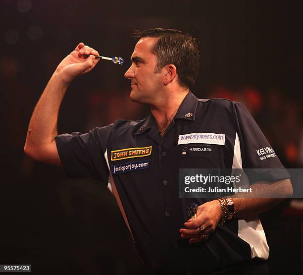 Ross Montgomery of Scotland in action against Garry Thompson of England during the first round Match of World Professional Darts Championship at The...