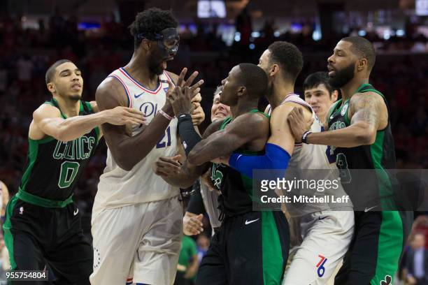 Joel Embiid of the Philadelphia 76ers gets into an altercation with Terry Rozier of the Boston Celtics as Jayson Tatum and Marcus Morris of the...