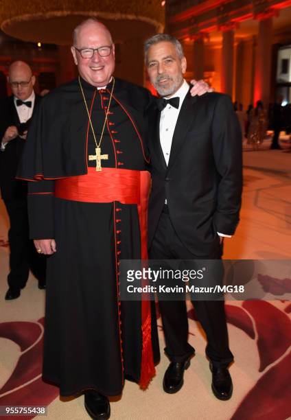 Cardinal Timothy Michael Dolan and George Clooney attend the Heavenly Bodies: Fashion & The Catholic Imagination Costume Institute Gala at The...