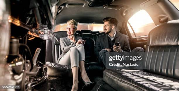 business meeting in limo - limousine stock pictures, royalty-free photos & images