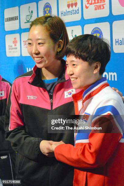 Yang Haeun of South Korea and KIM Song I of North Korean shake hands as they formed Team Corea on day five of the World Team Table Tennis...