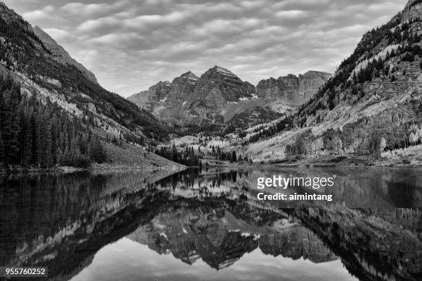 reflection of maroon peak and north maroon peak in maroon lake at maroon bells scenic area - white river national forest stock pictures, royalty-free photos & images